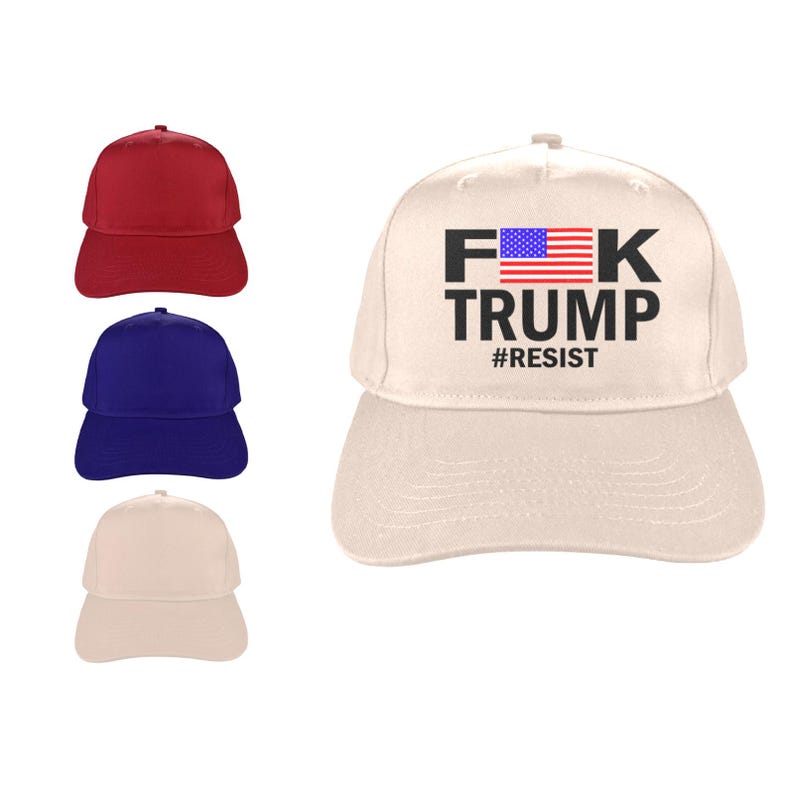 May include: Baseball caps in red, blue, and beige. A beige cap features the text "F*K TRUMP" with an American flag graphic and the hashtag "#RESIST". The caps are made of a durable fabric and have a curved brim.