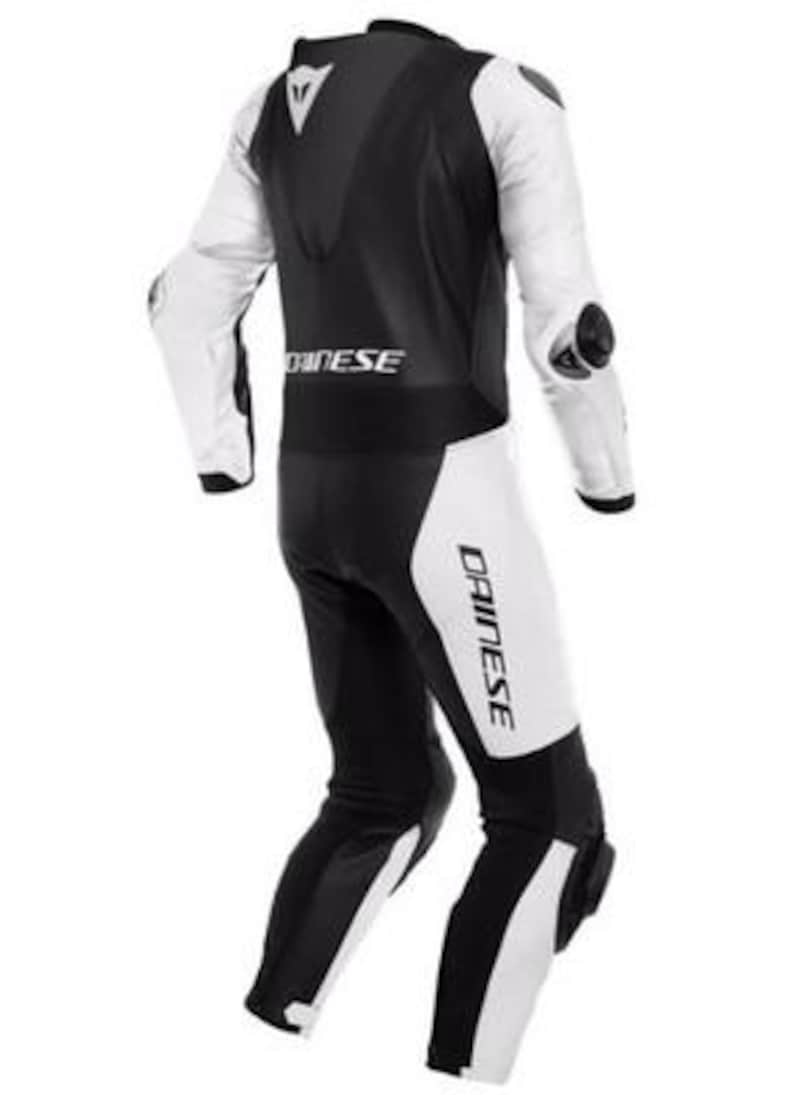 K&ouml;nnte beinhalten: Ein schwarzer und wei&szlig;er Motorrad-Rennanzug. Der Anzug hat wei&szlig;e &Auml;rmel und Bein-Panels, mit Schwarz am Oberk&ouml;rper und den Unterschenkeln. Der Markenname "DAINESE" ist auf dem Anzug aufgedruckt. Ellenbogen- und Kniesch&uuml;tzer sind sichtbar.