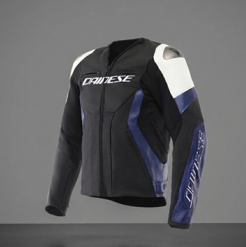 May include: Black and blue motorcycle jacket with white accents. The jacket features the brand name "DAINESE" in white lettering on the chest and sleeves. The jacket has a zipper closure and is designed for protection.