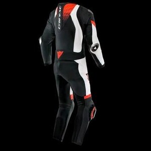 May include: Black and white motorcycle racing suit with red accents. The suit features a streamlined design with protective padding on the shoulders, elbows, and knees. The brand name "DAINESE" is visible on the back and chest.