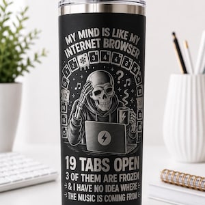 May include: A matte black stainless steel tumbler with a clear lid and straw. The graphic features a skeleton at a laptop with the text: MY MIND IS LIKE MY INTERNET BROWSER, 19 TABS OPEN, 3 OF THEM ARE FROZEN & I HAVE NO IDEA WHERE THE MUSIC IS COMING FROM.