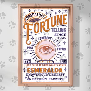 May include: Framed poster with a vintage design. The poster features the text "Esmeralda's Fortune Telling Since 1899" in orange and white. A large eye graphic is in the center, with "Past", "Present", and "Future" around it. The bottom reads "Esmeralda knows your deepest & darkest secrets."
