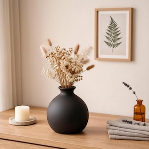 May include: A rustic wooden sign with the text "Welcome to our home" in white lettering. The sign features a distressed finish and a simple, inviting design, perfect for a front porch or entryway.