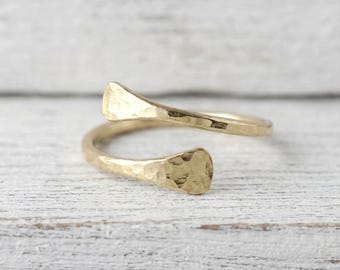 Anel envolvente martelado em prata de lei banhada a ouro 18k, estilo minimalista e ajustável.