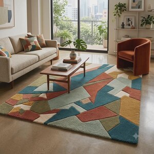 May include: A rectangular area rug featuring a geometric pattern with large, angular shapes in shades of teal, terracotta, mustard yellow, olive green, and cream. The rug has a textured, tufted pile and covers a portion of the floor in a living room.