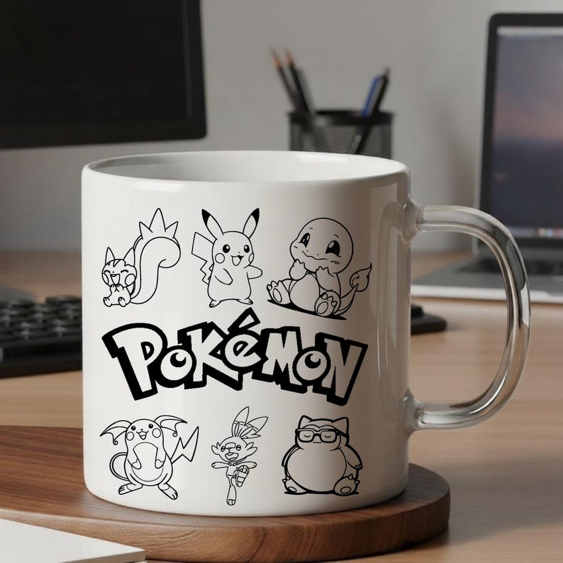 May include: White ceramic mug featuring black line drawings of various Pok&eacute;mon characters and the word "Pok&eacute;mon" in a bold font. The mug has a clear handle and is set on a wooden coaster.