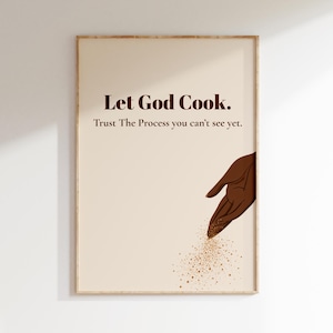 May include: A rectangular wall art print on a cream background featuring the dark brown text Let God Cook. Trust The Process you can't see yet. Below the text, a dark brown illustration of a hand sprinkles small golden particles downward.