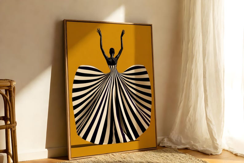 May include: A framed rectangular wall art print featuring a figure with dark skin and raised arms, wearing a voluminous gown with bold black and white vertical stripes against a solid mustard yellow background, set in a light wood frame.