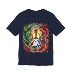 May include: Navy blue t-shirt featuring a colorful graphic design. The design includes a soccer ball, the World Cup trophy, and elements of various national flags. The shirt is a standard crew neck and short sleeve style.