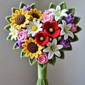 May include: A handcrafted crochet bouquet featuring a variety of colorful flowers. The bouquet includes sunflowers, daisies, roses, lilies, and poppies in shades of yellow, white, pink, red, and purple. The stems are wrapped in green yarn.