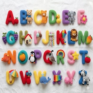 May include: A colorful crochet alphabet with each letter featuring a unique design. The letters are in various colors, with each letter decorated with a corresponding object or animal, such as a bear, duck, or zebra. The letters are arranged on a white surface.