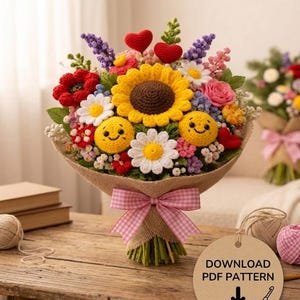Peut inclure: Un bouquet de crochet fait à la main avec un grand tournesol jaune, des marguerites blanches, des coquelicots rouges et des accents de smiley. Le bouquet est enveloppé de toile de jute et noué avec un ruban rose. L'image comprend une étiquette indiquant "DOWNLOAD PDF PATTERN".