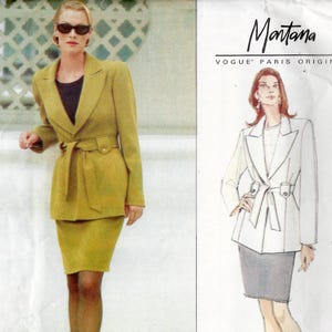 May include: A Vogue Paris Original Montana sewing pattern envelope 1838 featuring a two-piece suit with a belted jacket and a knee-length skirt. The cover displays a photograph of a mustard yellow suit and a corresponding fashion illustration.