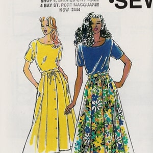 May include: A sewing pattern for two dresses, one yellow and one with a floral print. The pattern is called "Kwik-Sew" and the pattern number is 2253. The pattern is for sizes XS-S-M-L-XL.