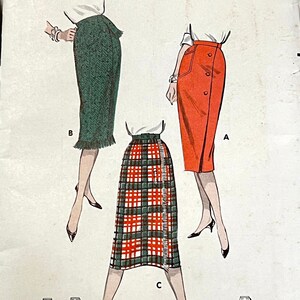 May include: A vintage sewing pattern for three different skirts. The skirts are a green herringbone, a red solid, and a plaid. The pattern is from Butterick and is size 24 1/2, hip 33 1/2.