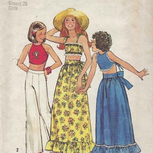 May include: A sewing pattern for girls' clothing, Simplicity pattern number 6367. The pattern includes three different outfits: a white top and pants, a yellow floral top and skirt, and a blue top and skirt. The pattern is for sizes 7-26.