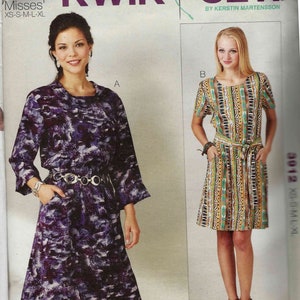 May include: A sewing pattern for "Uptown Dresses" featuring two dress designs. One dress is a long-sleeved, knee-length dress with a belt. The other is a short-sleeved dress with a belt. The pattern includes sizes XS-XL.