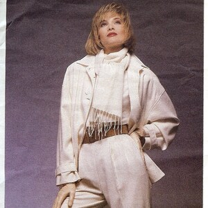 May include: Vogue Patterns American Designer sewing pattern 1488 by Joseph Picone. The envelope features an illustration and photograph of a cream-coloured ensemble consisting of a loose-fitting jacket, a long-sleeved top, and high-waisted trousers.