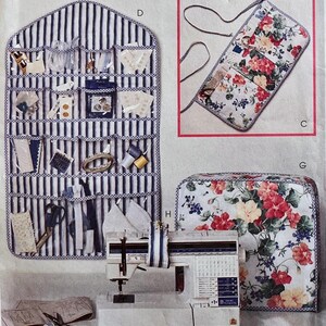 May include: A blue and white striped wall organizer with clear pockets containing sewing supplies, a floral fabric roll-up case with ties, a sewing machine, and a floral fabric cover. The items are labeled with the letters D, C, G, and H.