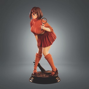 May include: A figurine of a cartoon character in a rust-colored turtleneck, pleated skirt, and knee-high socks, holding a magnifying glass. The character wears black glasses and brown shoes. The figurine is on a round, dark base.