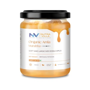 May include: A jar of Organic Amla Murabba (in Honey) with a black lid. The label reads "Soft and Large Size Edible Amla". The jar contains a golden-coloured preserve, with a honey-like drip design. The net weight is 450 grams.