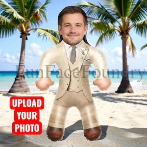 May include: A novelty inflatable doll featuring a man's face, wearing a tan suit with a tie and boutonniere, standing on a beach with palm trees. The doll has brown shoes and the text "FunFaceFoundry" is visible. A red rectangle with the text "UPLOAD YOUR PHOTO" is in the lower left.