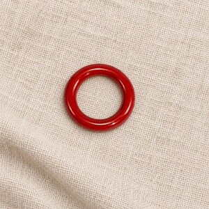 Red closed metal ring sample on natural linen; one selected colour option.