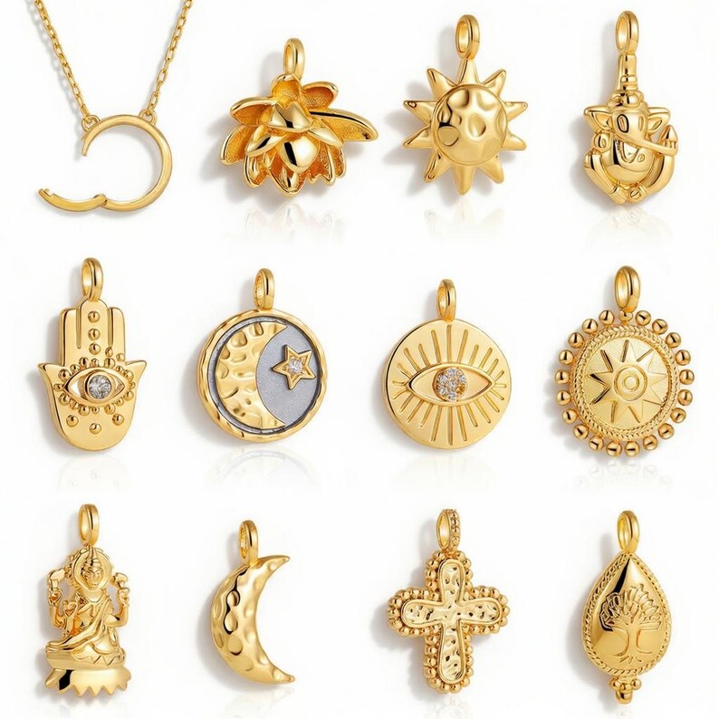 May include: A collection of gold-colored pendants, including a crescent moon, a lotus flower, a sun, a Hamsa hand with an eye, and a cross. The pendants are intricately designed and vary in shape and style, suitable for necklaces or bracelets.