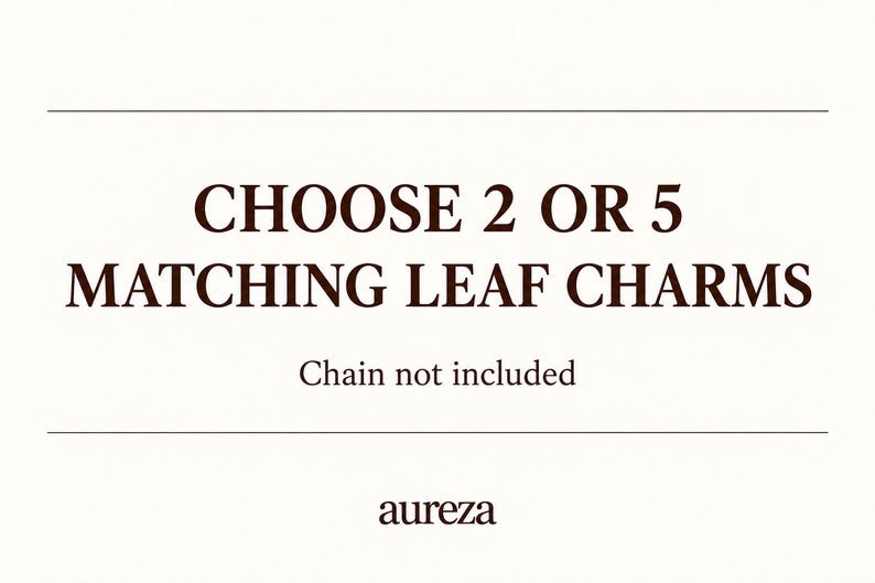 May include: A white rectangular sign with dark brown text that reads CHOOSE 2 OR 5 MATCHING LEAF CHARMS, followed by the text Chain not included, and the brand name aureza at the bottom, framed by two horizontal lines above and below the main text.