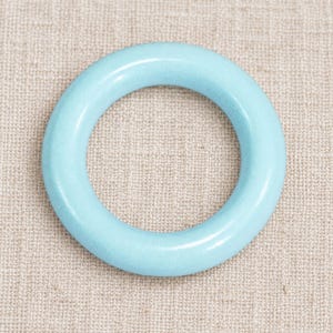 Light Blue closed ring on natural linen; one representative component.