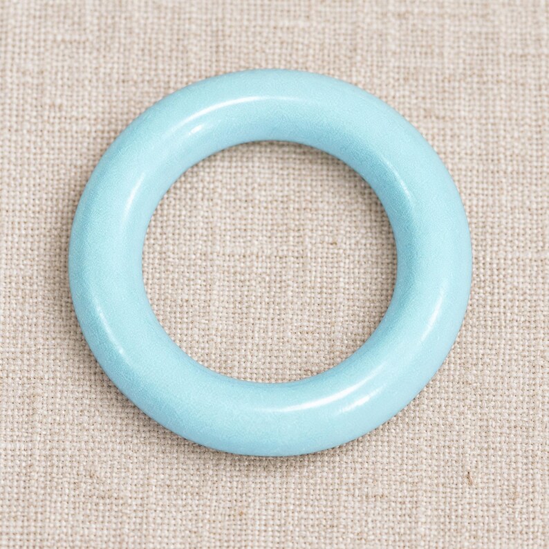 Light Blue closed ring on natural linen; one representative component.