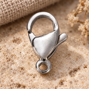 Silver stainless steel lobster clasps. Macro detail. 6 x 12mm. Buyer pack: 10 pieces.