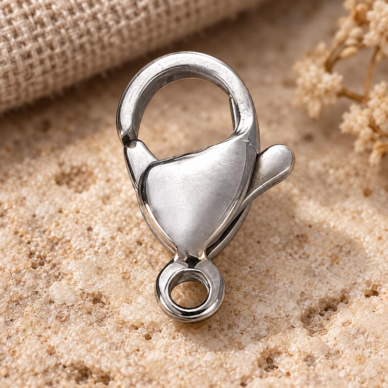 Silver stainless steel lobster clasps. Macro detail. 6 x 12mm. Buyer pack: 10 pieces.