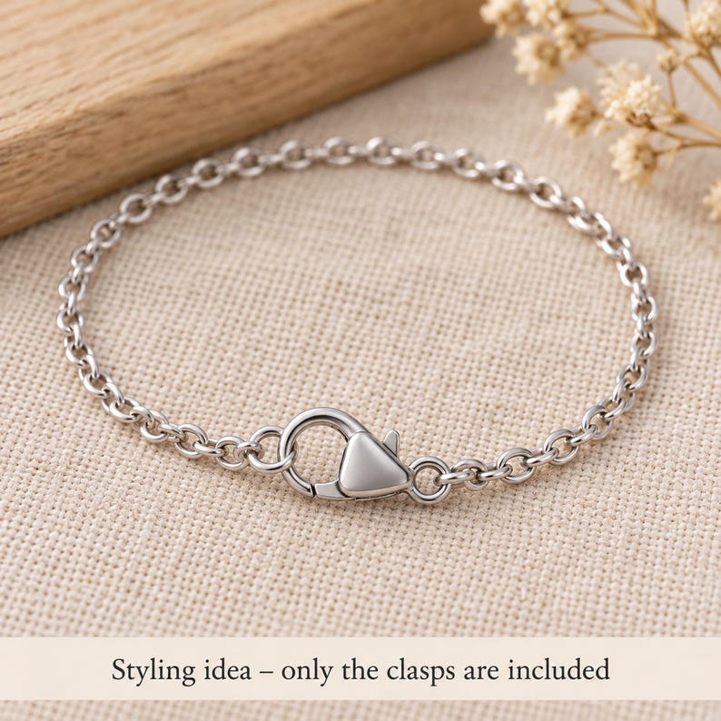 Silver stainless steel lobster clasps. Styling idea; finished jewellery is not included. 6 x 12mm. Buyer pack: 10 pieces.