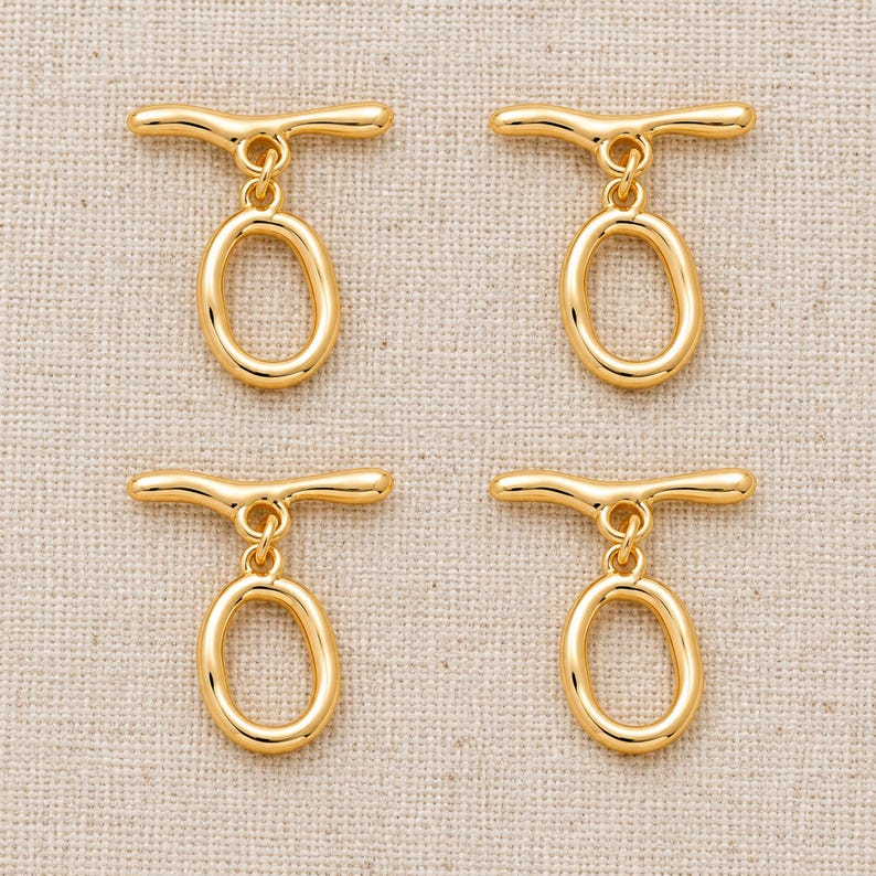Gold-tone brass oval toggle clasps. Pack flat lay; quantity check pending. ring 20 x 12.5mm; T-bar 23.8mm. Buyer pack: 4 complete clasp sets.
