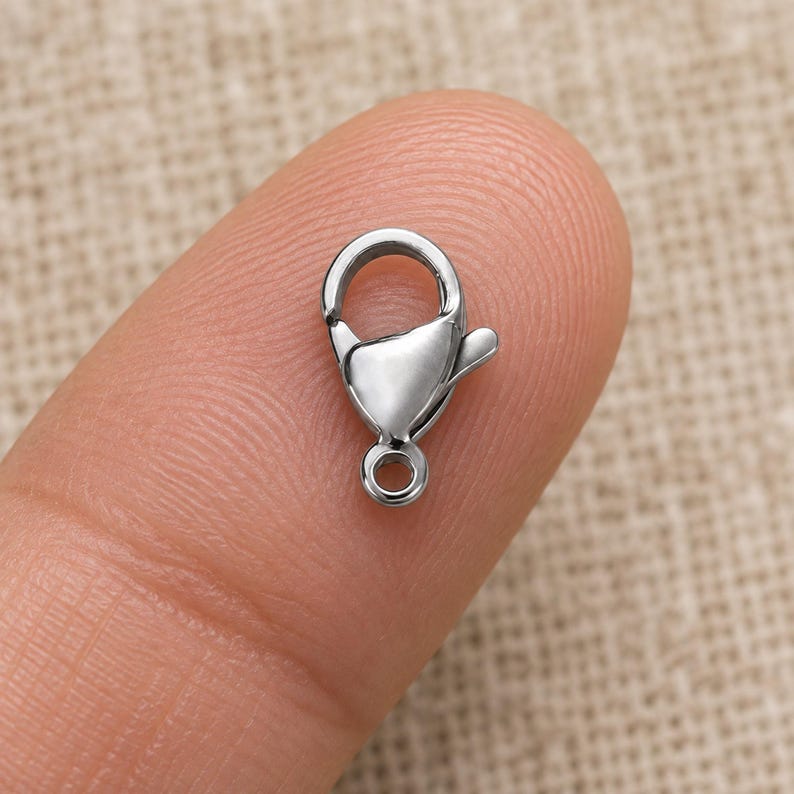 Silver stainless steel lobster clasps. Scale reference preview. 6 x 12mm. Buyer pack: 10 pieces.