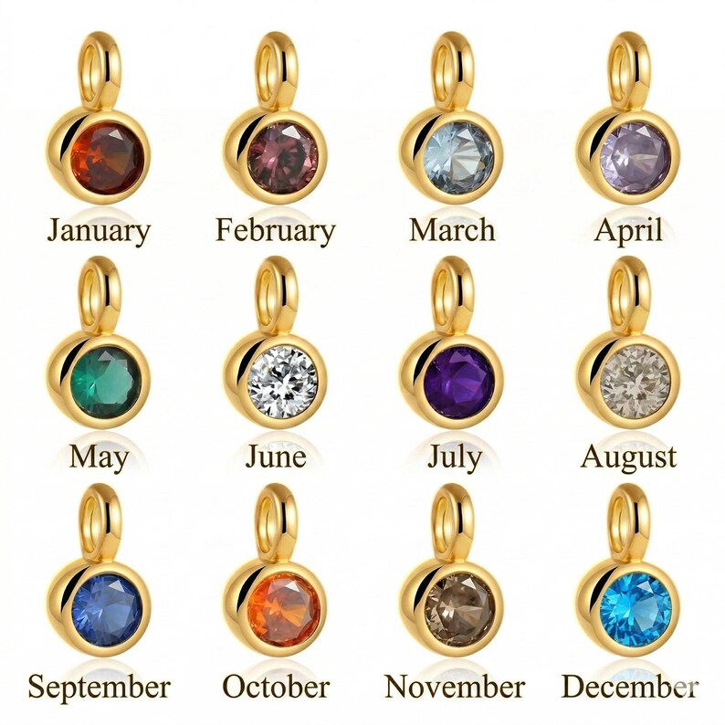 May include: Gold-colored pendants with birthstones for each month of the year. Each pendant features a round gemstone in a different color, with the month's name printed below. The gemstones include red, purple, blue, green, and clear.