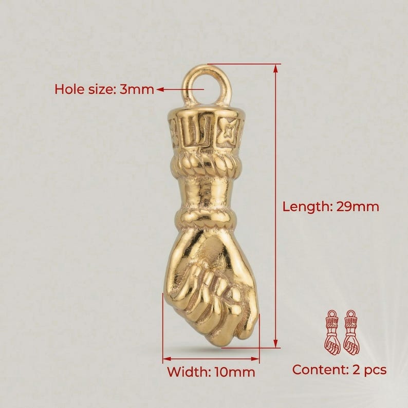 May include: Gold-colored fist-shaped charm with a 3mm hole, 29mm length, and 10mm width. The charm has a detailed design and includes the text "Content: 2 pcs".
