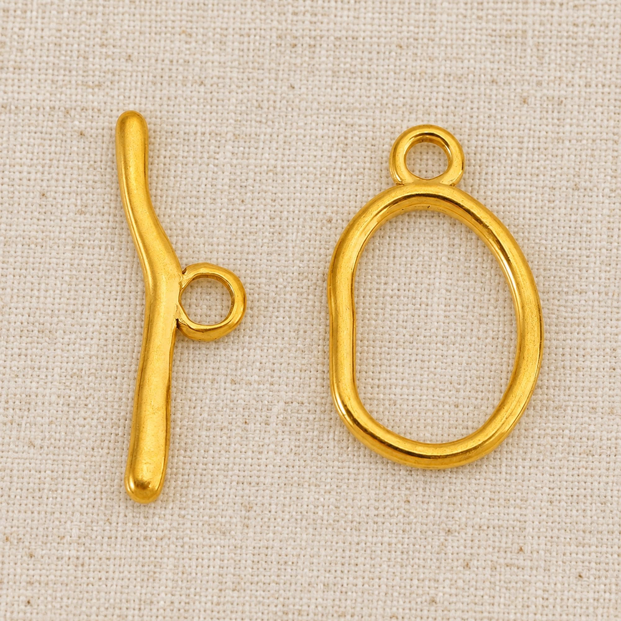 Toggle clasp, gold-tone steel oval 25x15mm or 21.5x14mm, curved 28.5mm/19.5mm bars, 5 sets