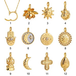 May include: A collection of gold-colored pendants with various designs, including a crescent moon, sun, lotus flower, and cross. Some pendants feature gemstones. The pendants are displayed against a white background.