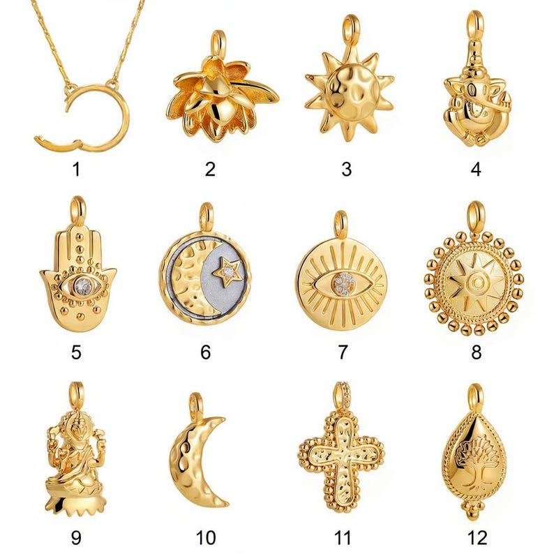 May include: A collection of gold-colored pendants with various designs, including a crescent moon, sun, lotus flower, and cross. Some pendants feature gemstones. The pendants are displayed against a white background.