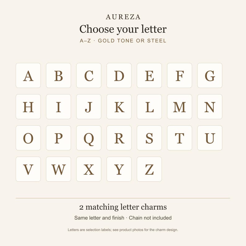 May include: A selection chart for letter charms featuring the brand name AUREZA, the text Choose your letter, A-Z GOLD TONE OR STEEL, and a grid of letters from A to Z in a serif font. Below, the text reads 2 matching letter charms, Same letter and finish, Chain not included.