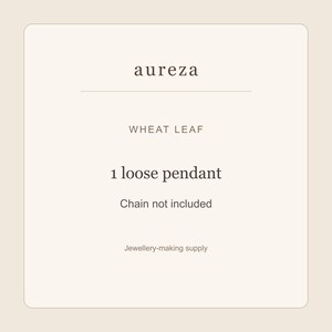 May include: A square graphic card with a light beige background and dark brown text. The text reads: aureza, WHEAT LEAF, 1 loose pendant, Chain not included, Jewellery-making supply. The design is centered with a horizontal line separating the brand name.