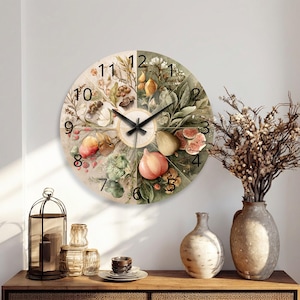 May include: A round wall clock featuring a segmented botanical illustration of various fruits, vegetables, and foliage in muted earth tones. The clock face displays black Arabic numerals from one to twelve and black hour, minute, and second hands.