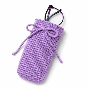 May include: A lavender crochet glasses case featuring a rectangular pouch design with a drawstring closure tied in a bow at the top. The case is constructed with a dense, uniform stitch pattern and contains a pair of dark purple eyeglasses.