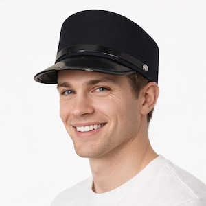 May include: A navy blue hat with a black visor and a shiny black band. The hat has a rounded top and a small silver button on the side. The hat is a classic style.