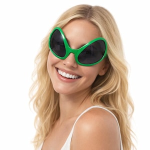 May include: Green alien-eye sunglasses with black lenses. The sunglasses have a unique, curved shape, and are worn by a person with blonde hair and a white tank top. The sunglasses are a fun, novelty item.