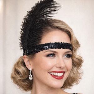 May include: A white ceramic mug with a black handle and the text "But First, Coffee" in a bold, black font. The mug is set against a blurred background, suggesting a cozy setting. The mug appears to be approximately 4 inches tall.