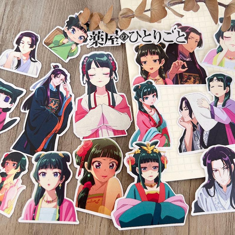May include: A selection of anime-style stickers depicting characters in traditional Asian clothing. The stickers display detailed illustrations with vibrant colours, including pink, green, and blue, and some have Japanese text.