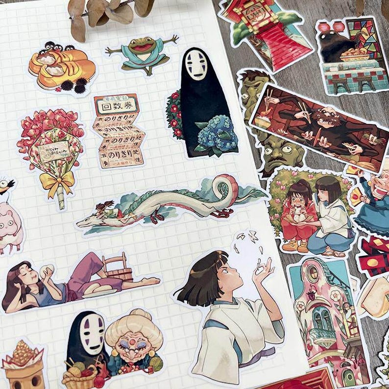 May include: A collection of colorful anime-style stickers featuring characters and scenes. Includes a dragon, a frog, a faceless spirit, and other figures. The stickers are on a white grid background.